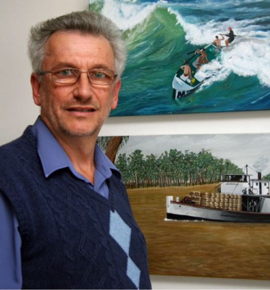 Mori with two paintings by his artist wife, Kham; a Palm Beach surfboat and the 1910 Murray River paddle steamer Pevensey